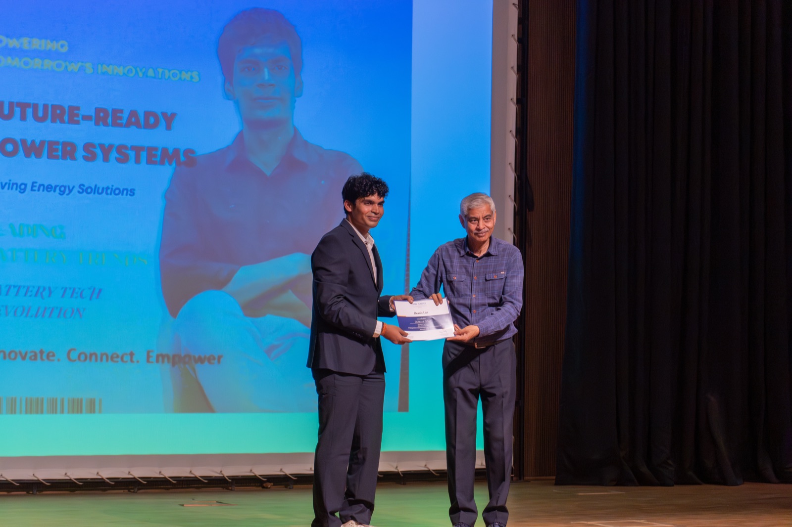 Siddharth Patel receiving the Dean's List award on stage from Dr. Suneet Tuli, Dean of Engineering